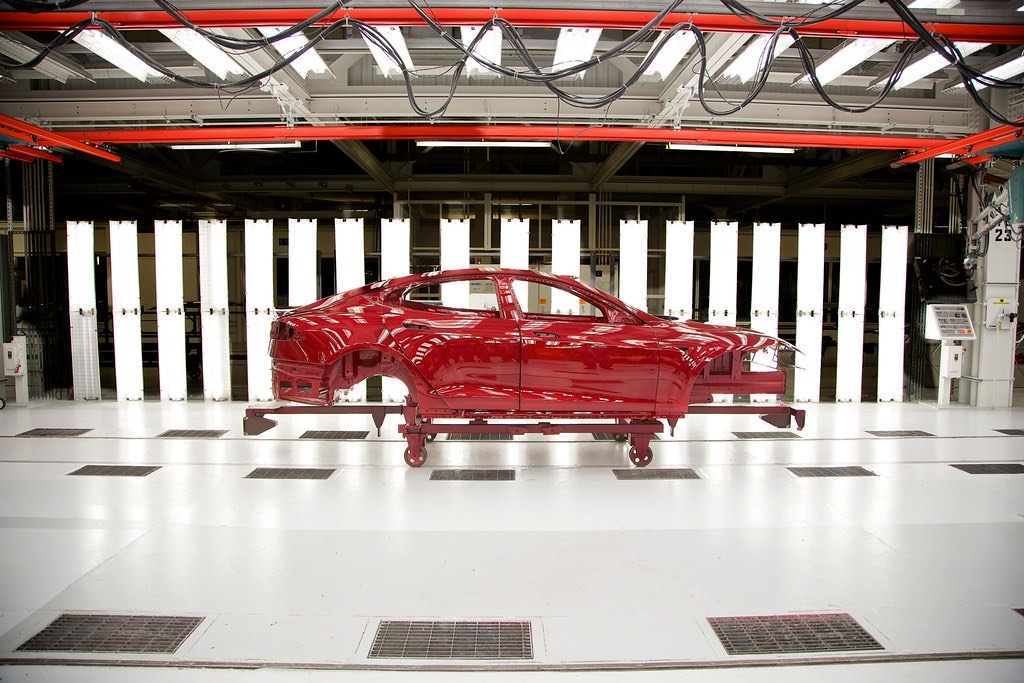 Vehicle body on a carrier moving through a paint line